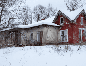 Home covered with snow during winter, symbolizing common winter home problems.
